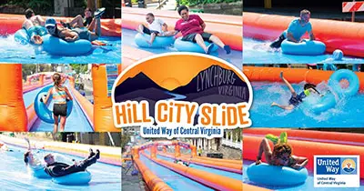 people on blue innertubes enjoying waterslides at Hill City Slide event