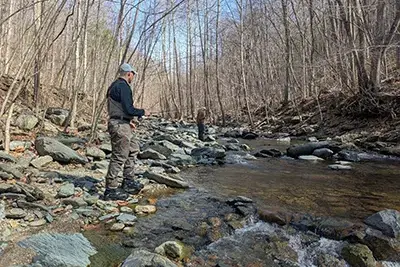 Man fishing in a rocky stream