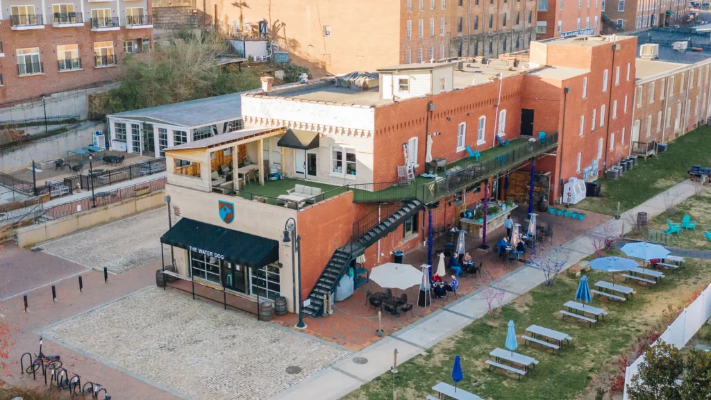 Outside of The Water Dog with outdoor picnic tables and rooftop seating