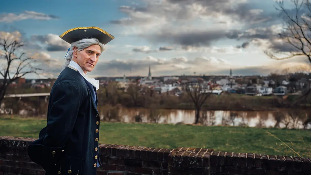 George Washington re-enactor looking down on the City of Fredericksburg and Rappahannock River